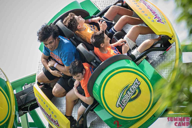 a group of four campers on an amusement park ride